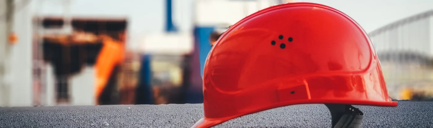 Red safety helmet in a construction setting